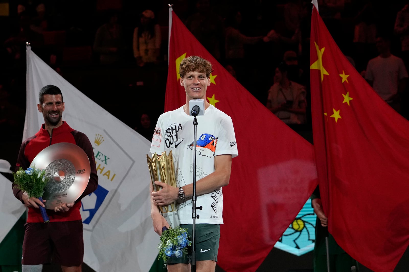 Jannik Sinner of Italy speaks with his trophy after defeating Novak Djokovic of Serbia in the men's singles finals match for the Shanghai Masters tennis tournament at Qizhong Forest Sports City Tennis Center in Shanghai, China, Sunday, Oct. 13, 2024. (AP Photo/Andy Wong)