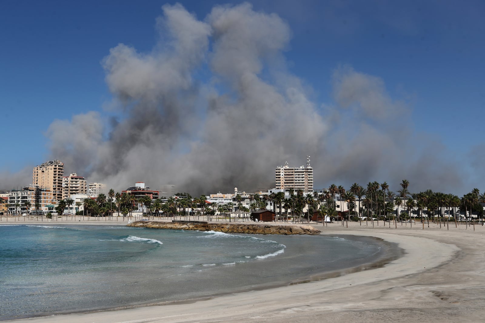 Smoke rises from buildings hit in Israeli airstrikes in Tyre, Lebanon, Wednesday, Oct. 23, 2024. (AP Photo/Mohammad Zaatari)