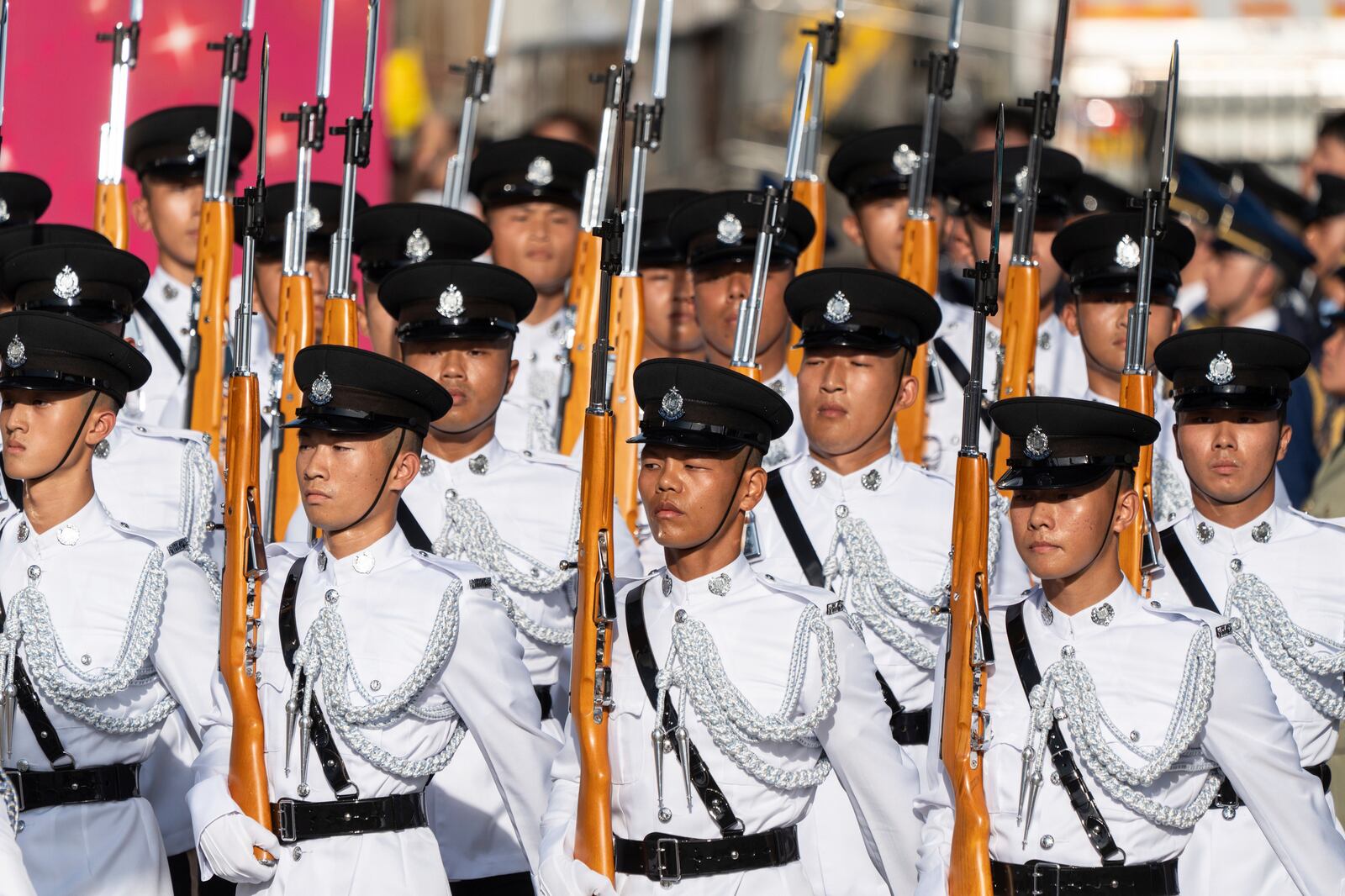 A Hong Kong police guard of honor marches in during a flag raising ceremony for the celebration of the 75th National Day of the People's Republic of China in Hong Kong, Tuesday, Oct. 1, 2024. (AP Photo/Chan Long Hei)