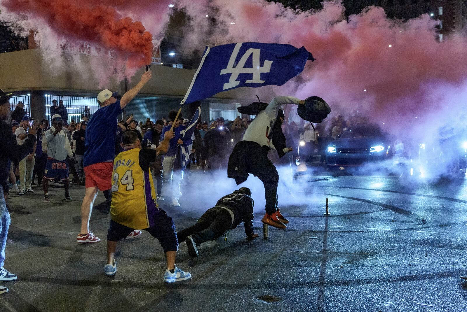 Fans celebrate on the streets after the Los Angeles Dodgers won against the New York Yankees in the baseball World Series Wednesday, Oct. 30, 2024, in Los Angeles. (AP Photo/Damian Dovarganes)