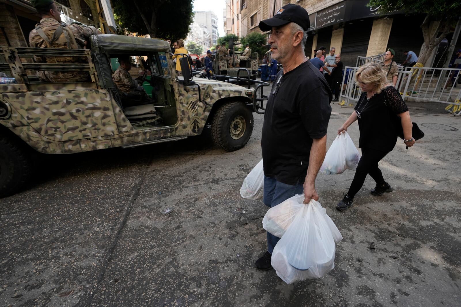 Lebanese soldiers drive near the site of Friday's Israeli strike in Beirut's southern suburb, Sunday, Sept. 22, 2024. (AP Photo/Bilal Hussein)