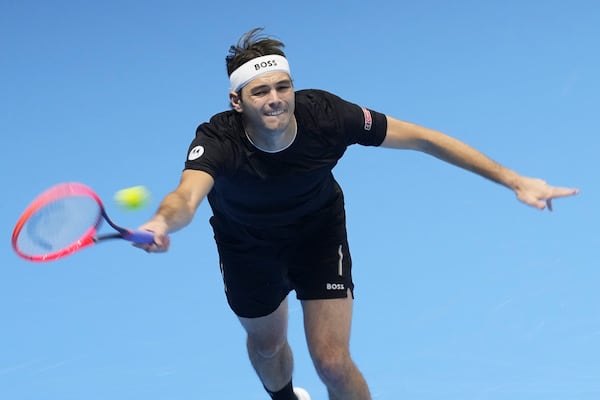 Taylor Fritz of the United States returns to Germany's Alexander Zverev during their semifinal tennis match of the ATP World Tour Finals at the Inalpi Arena in Turin, Italy, Saturday, Nov. 16, 2024. (AP Photo/Antonio Calanni)