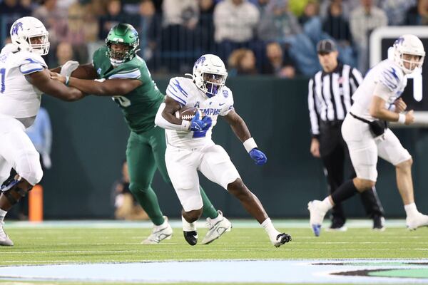 Memphis running back Mario Anderson Jr. (2) runs for yardage against Tulane during the first half of an NCAA college football game in New Orleans, Thursday, Nov. 28, 2024. (AP Photo/Peter Forest)