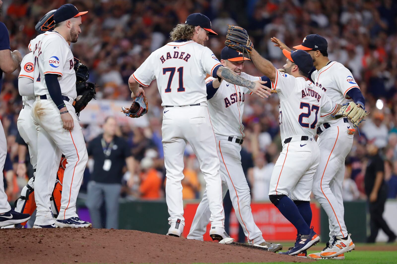 Houston Astros players gather at the mound to celebrate their 4-3 win over the Seattle Mariners to clinch the AL West title at the end of a baseball game Tuesday, Sept. 24, 2024, in Houston. (AP Photo/Michael Wyke)