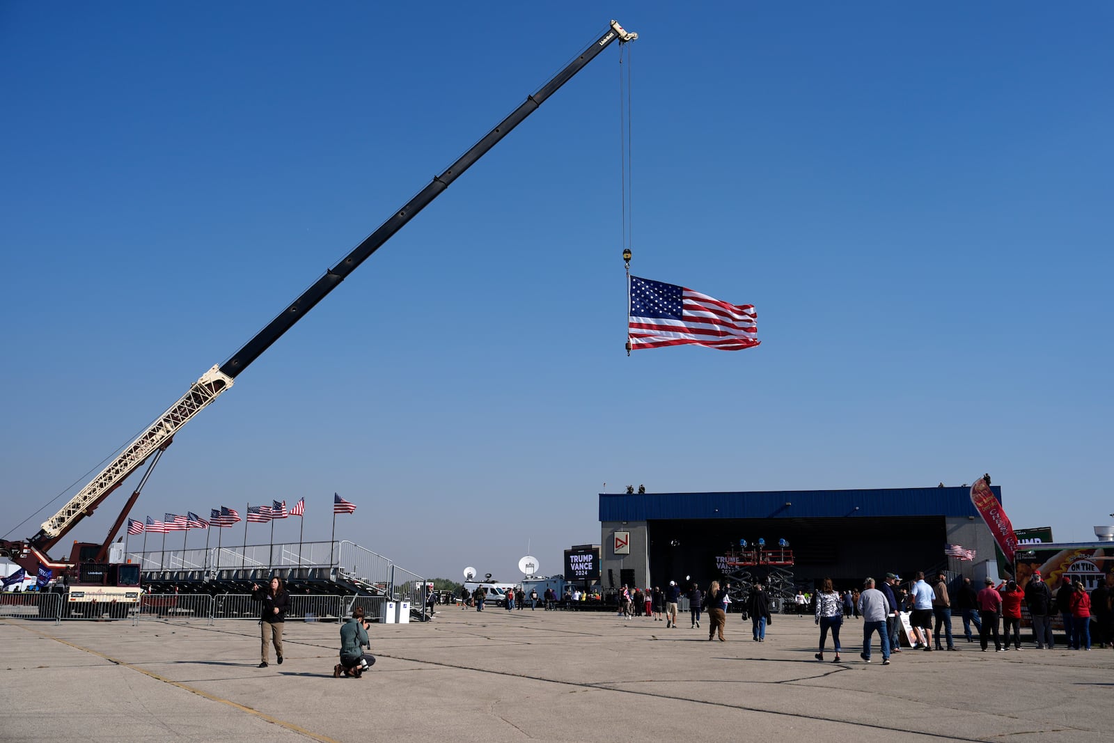 Attendees arrive at a campaign rally for Republican presidential nominee former President Donald Trump at Dodge County Airport, Sunday, Oct. 6, 2024, in Juneau, Wis. (AP Photo/Julia Demaree Nikhinson)