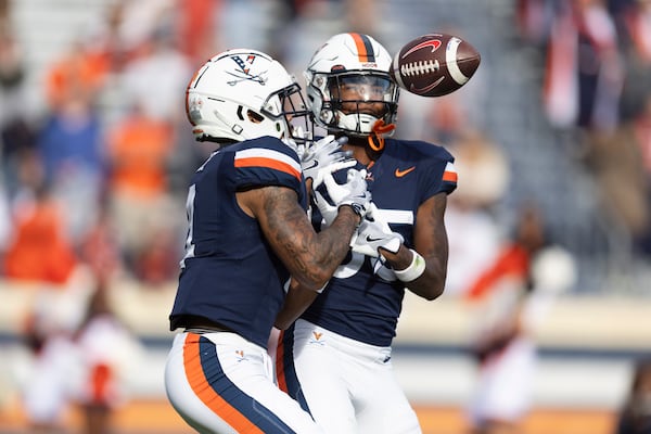 Virginia wide receiver Chris Tyree (4) and wide receiver Kameron Courtney (85) drop the ball during the second half of an NCAA college football game against SMU Saturday, Nov. 23, 2024, in Charlottesville, Va. (AP Photo/Mike Kropf)