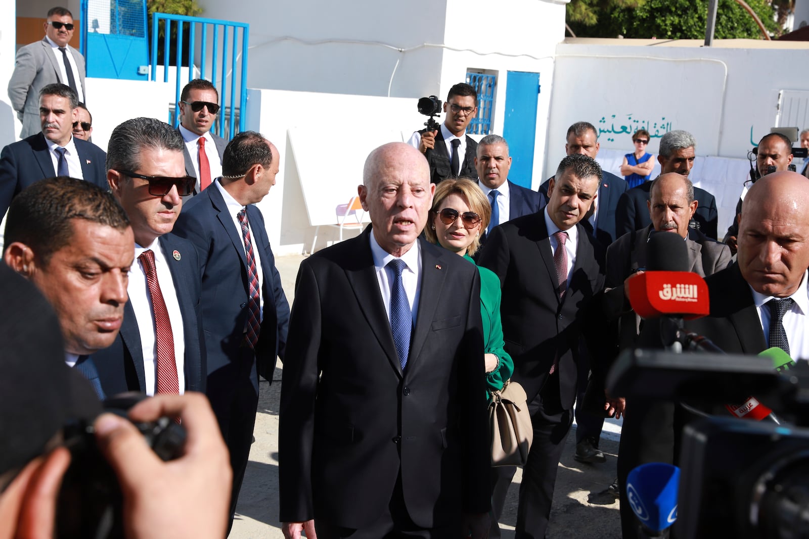 Tunisian President and candidate for re-election Kais Saied and his wife Ichraf Chebil Saïed, leave a polling station after casting their votes, at Mnihla, in the capital Tunis, Tunisia, Sunday, Oct. 6, 2024. (AP Photo/Anis Mili)