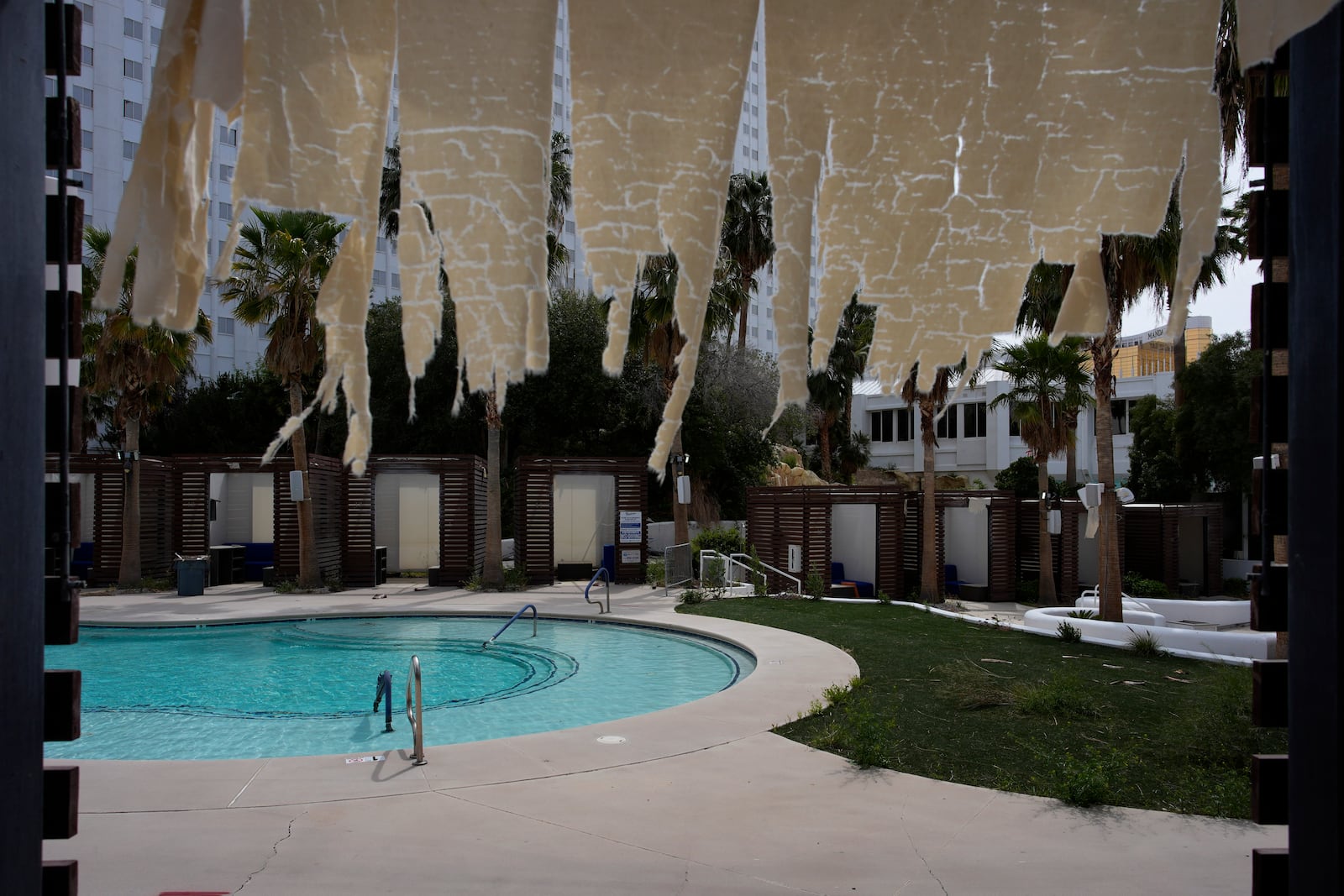 FILE - A tattered fabric hangs from a cabana at the shuttered pool area at the Tropicana hotel-casino Friday, March 29, 2024, in Las Vegas. (AP Photo/John Locher, File)