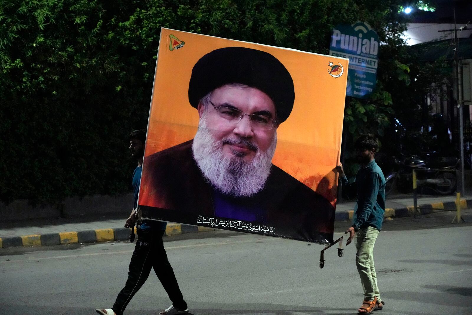 Supporters of a Pakistani Shiite Muslim group 'Imamia Student Organization' hold the portrait of Hezbollah leader Hassan Nasrallah, during a protest against the killing of him, in Lahore, Pakistan, Saturday, Sept. 28, 2024. (AP Photo/K.M. Chaudary)