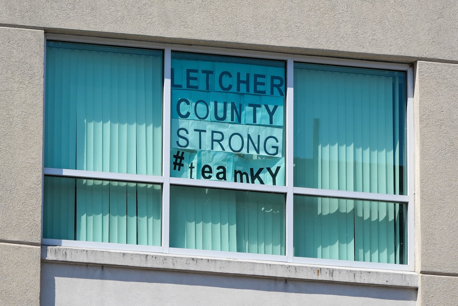 A sign is posted in the window at the Letcher County County Courthouse on Friday, Sept. 20, 2024, in Whitesburg, Ky. A preliminary investigation indicates Letcher County Sheriff Shawn “Mickey” Stines shot District Judge Kevin Mullins multiple times following an argument inside the courthouse, according to Kentucky State Police. (AP Photo/Randy Sartin)