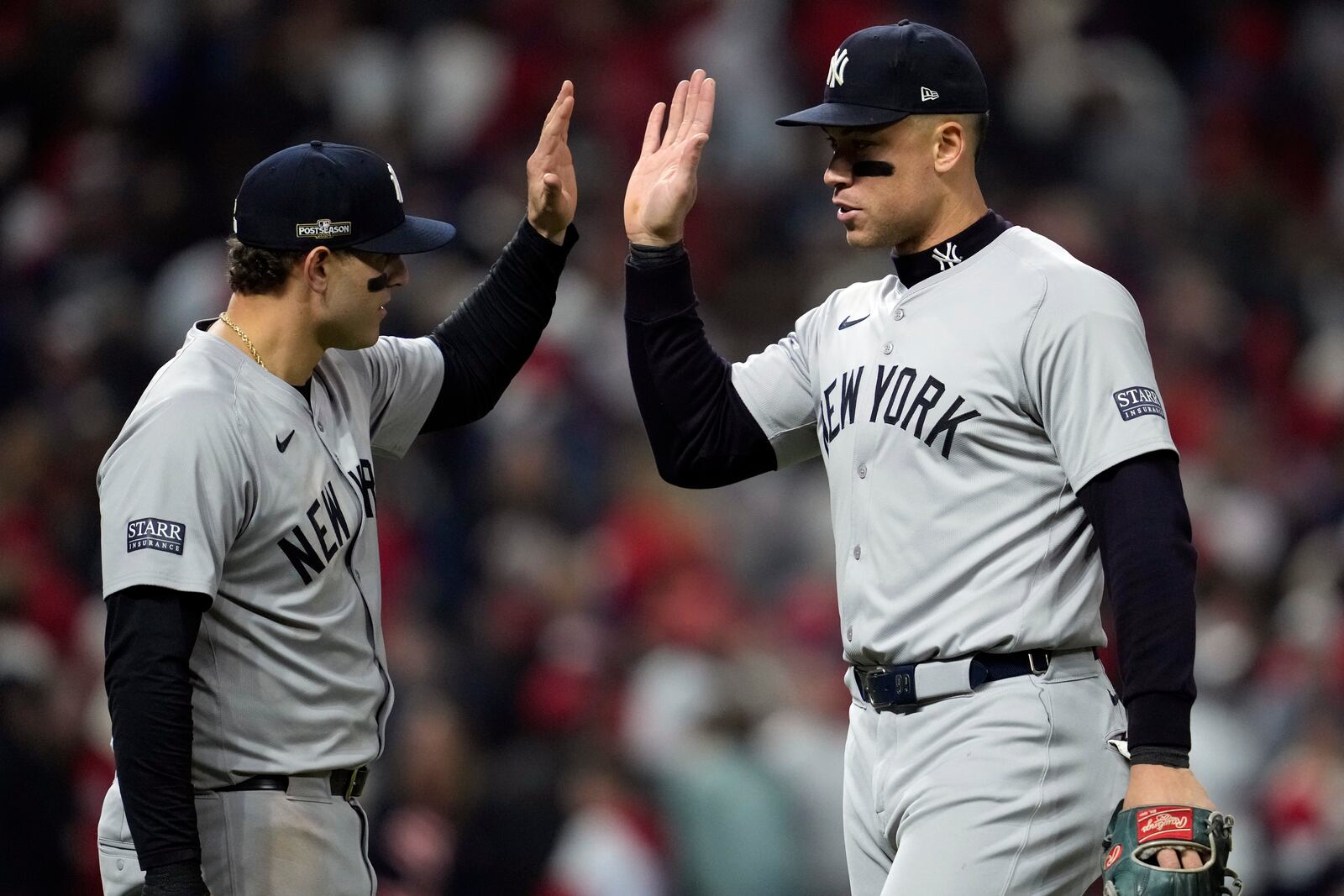 New York Yankees' Aaron Judge, right, and Anthony Rizzo celebrate after Game 4 of the baseball AL Championship Series against the Cleveland Guardians Friday, Oct. 18, 2024, in Cleveland. The Yankees won 8-6 to take a 3-1 lead in the best-of-seven series. (AP Photo/Godofredo A. Vásquez)