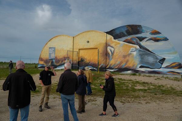 Tourists stand outside the Polar Bear Holding Facility, Sunday, Aug. 4, 2024, in Churchill, Manitoba. (AP Photo/Joshua A. Bickel)