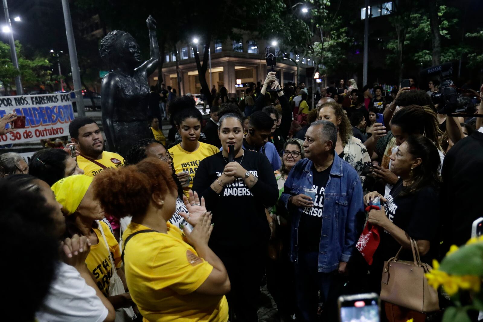 Luyara Santos, the daughter of slain councilwoman Marielle Franco, speaks next to a sculpture of Franco, after a judge sentenced two former police officers for the 2018 murder of Franco and her driver Anderson Gomes, at Buraco do Lume square in Rio de Janeiro, Thursday, Oct. 31, 2024. (AP Photo/Bruna Prado)