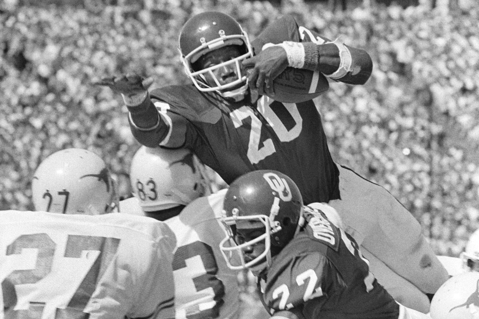 FILE - Oklahoma's Billy Sims (20) goes airborne in an effort to score from the two -yard line in the first quarter of an NCAA college football game against Texas, Saturday Oct.7, 1978, in Dallas. (AP Photo/File)