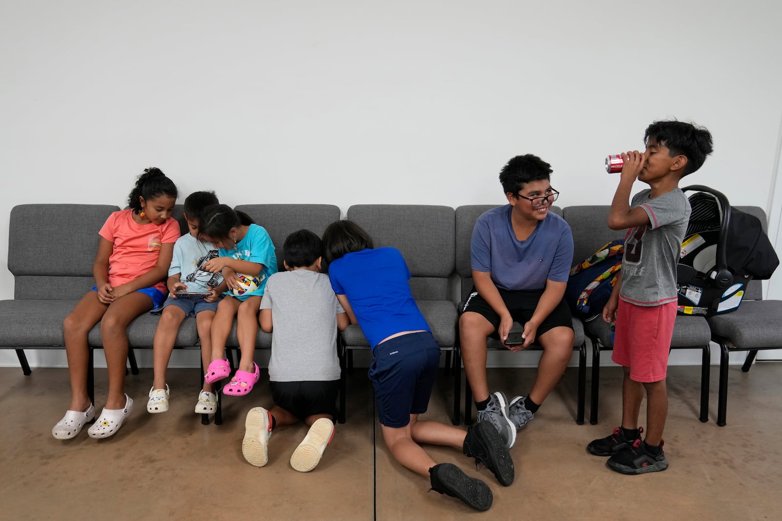 Children talk and play games inside St. Michael the Archangel Catholic church in the aftermath of Hurricane Helene Friday, Oct. 4, 2024, in Erwin, Tenn. (AP Photo/Jeff Roberson)