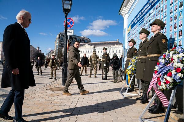 FILE - US President Joe Biden, left, participates in a wreath laying ceremony with Ukrainian President Volodymyr Zelenskyy at the memorial wall outside of St. Michael's Golden-Domed Cathedral during an unannounced visit, in Kyiv, Ukraine, Monday, Feb. 20, 2023. (AP Photo/Evan Vucci, File)