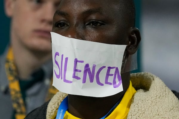 An activist participates in a demonstration with the word silenced over his mouth at the COP29 U.N. Climate Summit, Saturday, Nov. 16, 2024, in Baku, Azerbaijan. (AP Photo/Rafiq Maqbool)