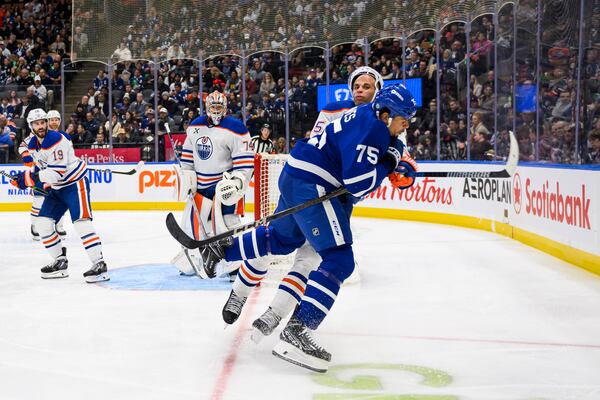 Toronto Maple Leafs right wing Ryan Reaves (75) collides with Edmonton Oilers defenseman Darnell Nurse (25) during the second period of an NHL hockey game, Saturday, Nov. 16, 2024 in Toronto. (Christopher Katsarov/The Canadian Press via AP)