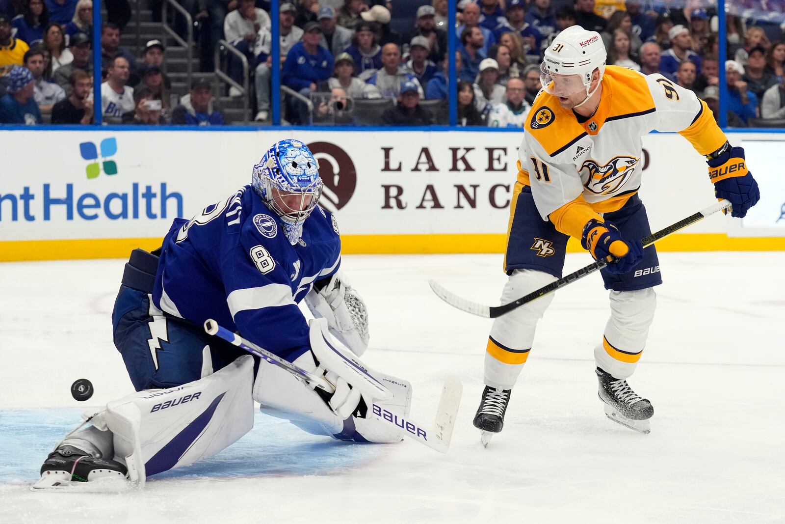 Nashville Predators center Steven Stamkos (91) shoots wide of Tampa Bay Lightning goaltender Andrei Vasilevskiy (88) during the third period of an NHL hockey game Monday, Oct. 28, 2024, in Tampa, Fla. (AP Photo/Chris O'Meara)