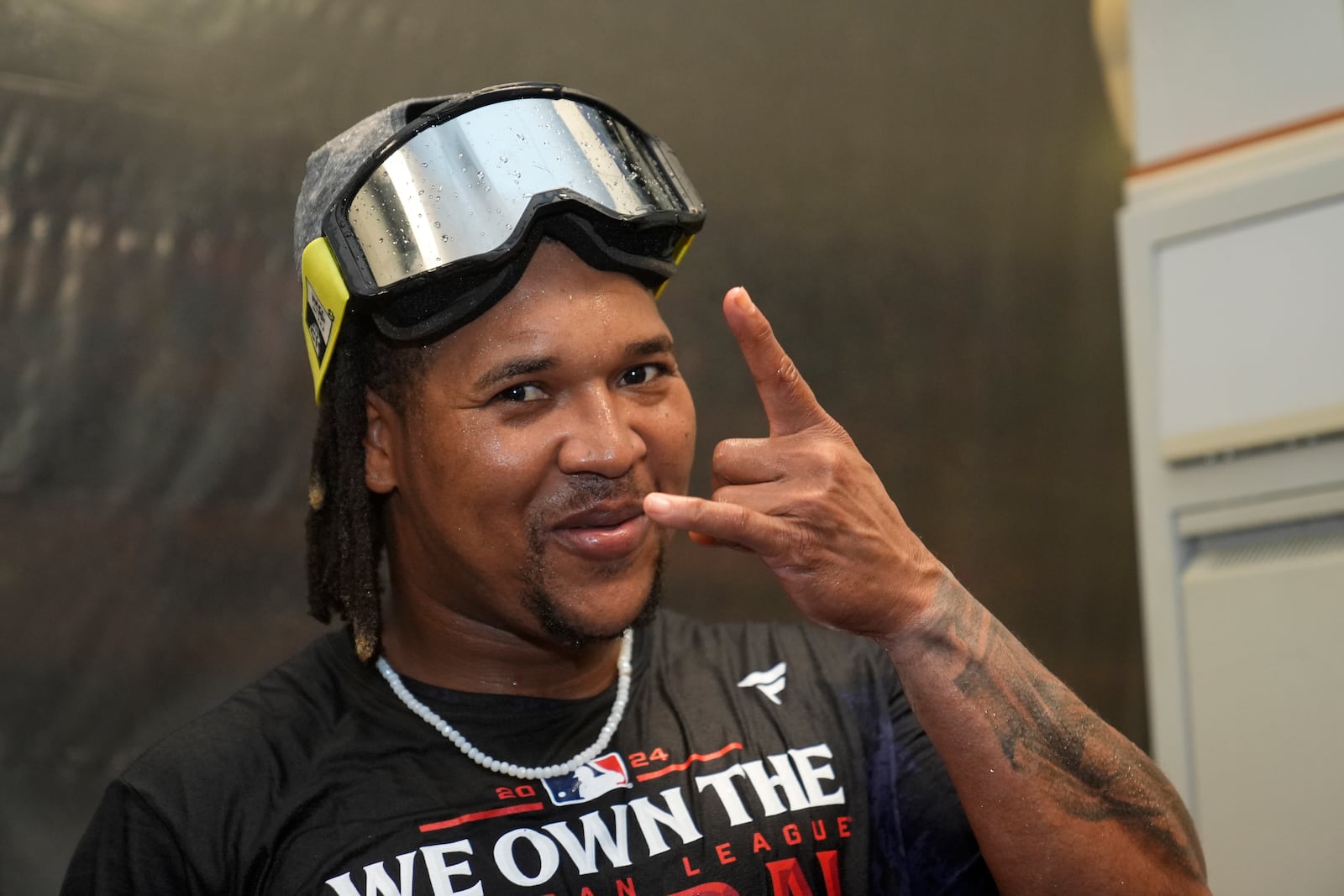 Cleveland Guardians' Jose Ramirez celebrates with teammates in the clubhouse after winning the American League Central following a baseball game against the St. Louis Cardinals Saturday, Sept. 21, 2024, in St. Louis. (AP Photo/Jeff Roberson)