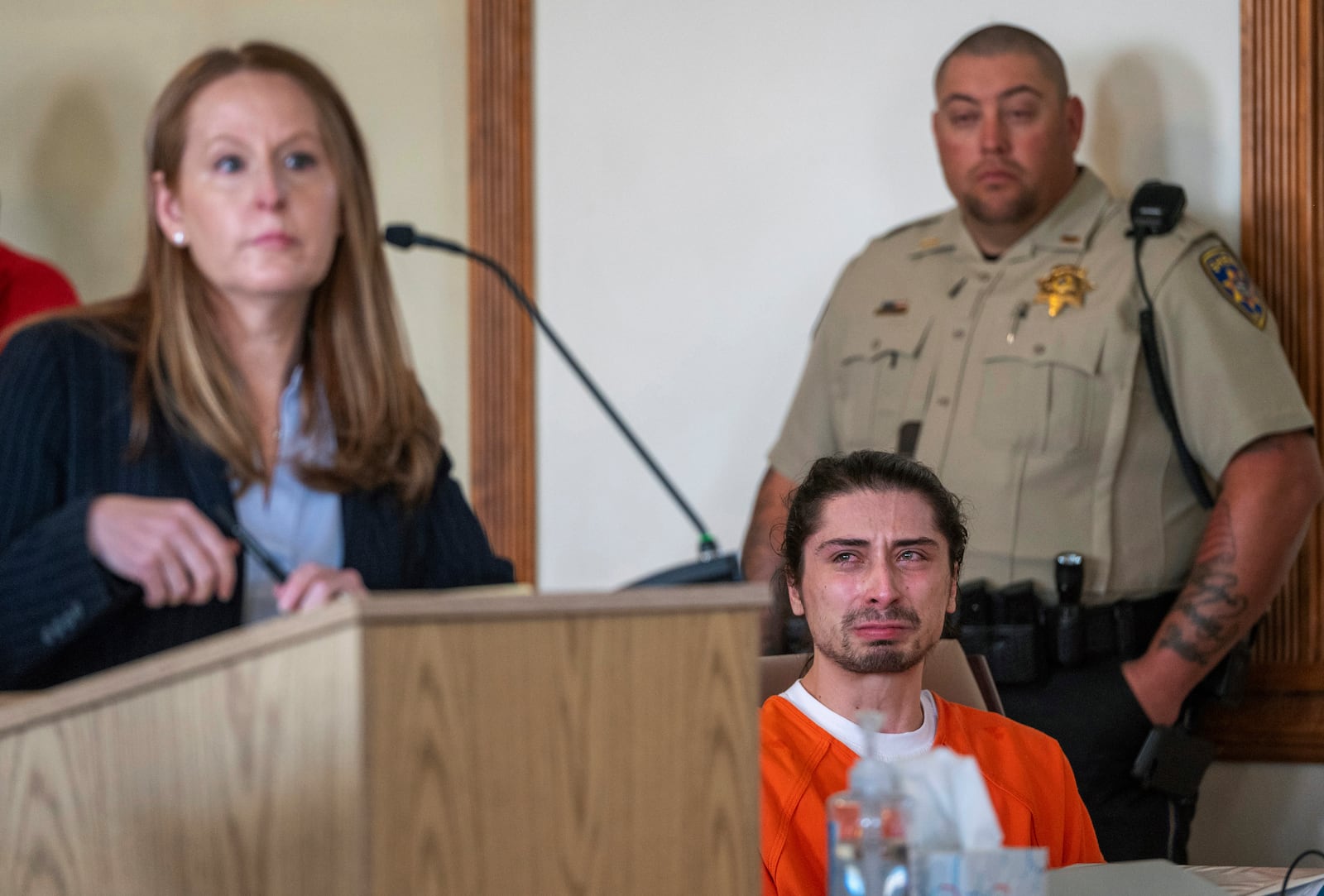 FILE - Ryan Martinez, seated, cries during his preliminary and detention hearing in Tierra Amarilla, N.M., Friday, Oct. 13, 2023, as his attorney Nicole Moss, describes the events that led to him allegedly shooting Jacob Johns during a rally outside the Rio Arriba County Complex in Espanola. (Eddie Moore/The Albuquerque Journal via AP, File)