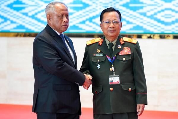 Laos' Defense Minister Chansamone Chanyalath, right, greets Brunei's Defense Minister II Halbi bin Haji Mohd Yussof during the Association of Southeast Asian Nations (ASEAN) defense ministers' meeting in Vientiane, Laos, Wednesday, Nov. 20, 2024. (AP Photo/Anupam Nath)