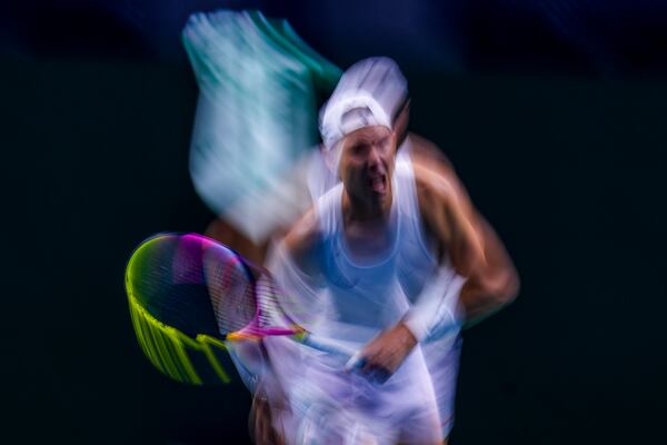 In this image taken with a slow shutter speed, Spain's tennis player Rafael Nadal gestures during a training session at the Martin Carpena Sports Hall, in Malaga, southern Spain, on Friday, Nov. 15, 2024. (AP Photo/Manu Fernandez)