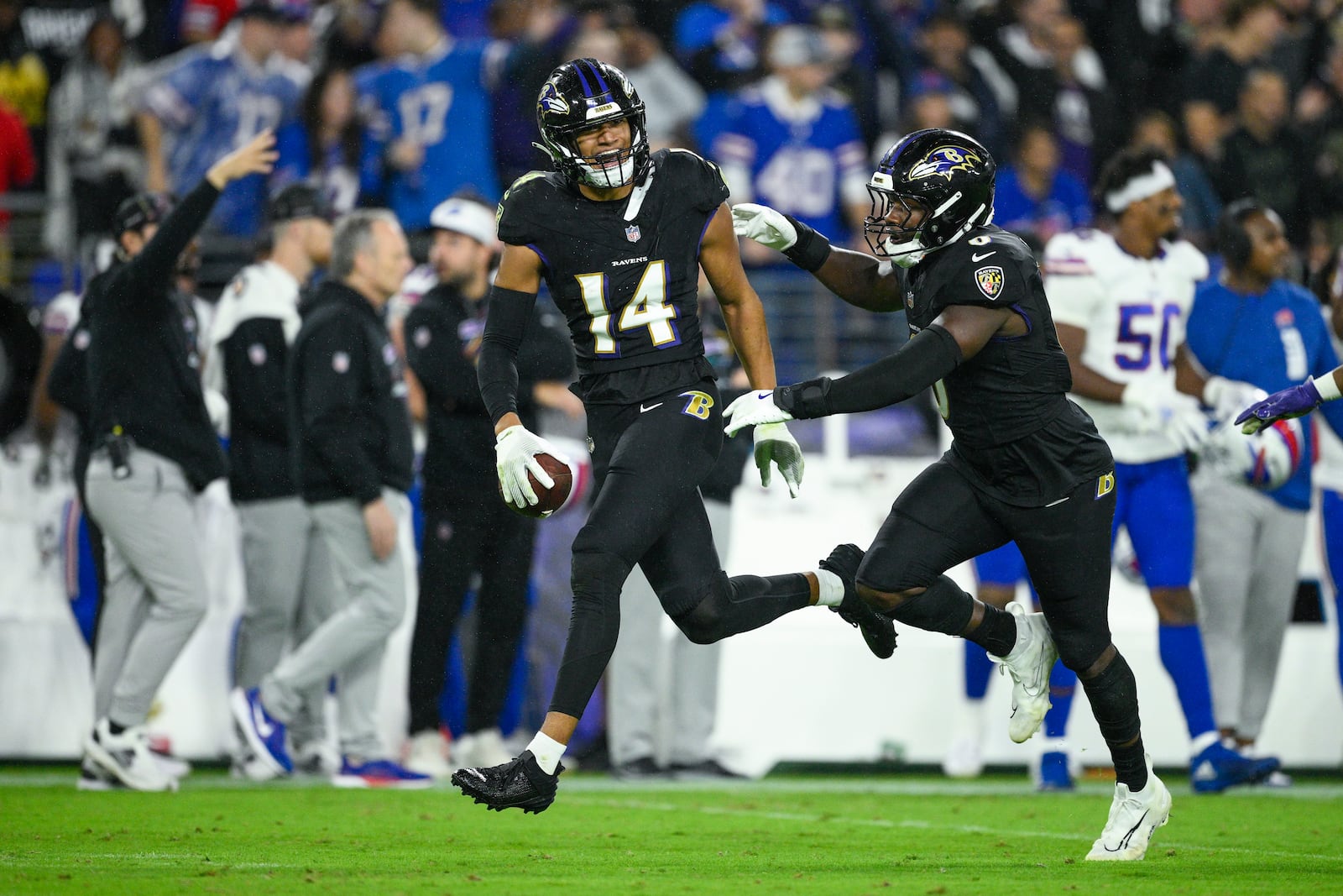 Baltimore Ravens safety Kyle Hamilton (14) reacts with teammate linebacker Roquan Smith after recovering a fumble by Buffalo Bills quarterback Josh Allen during the second half of an NFL football game, Sunday, Sept. 29, 2024, in Baltimore. (AP Photo/Nick Wass)