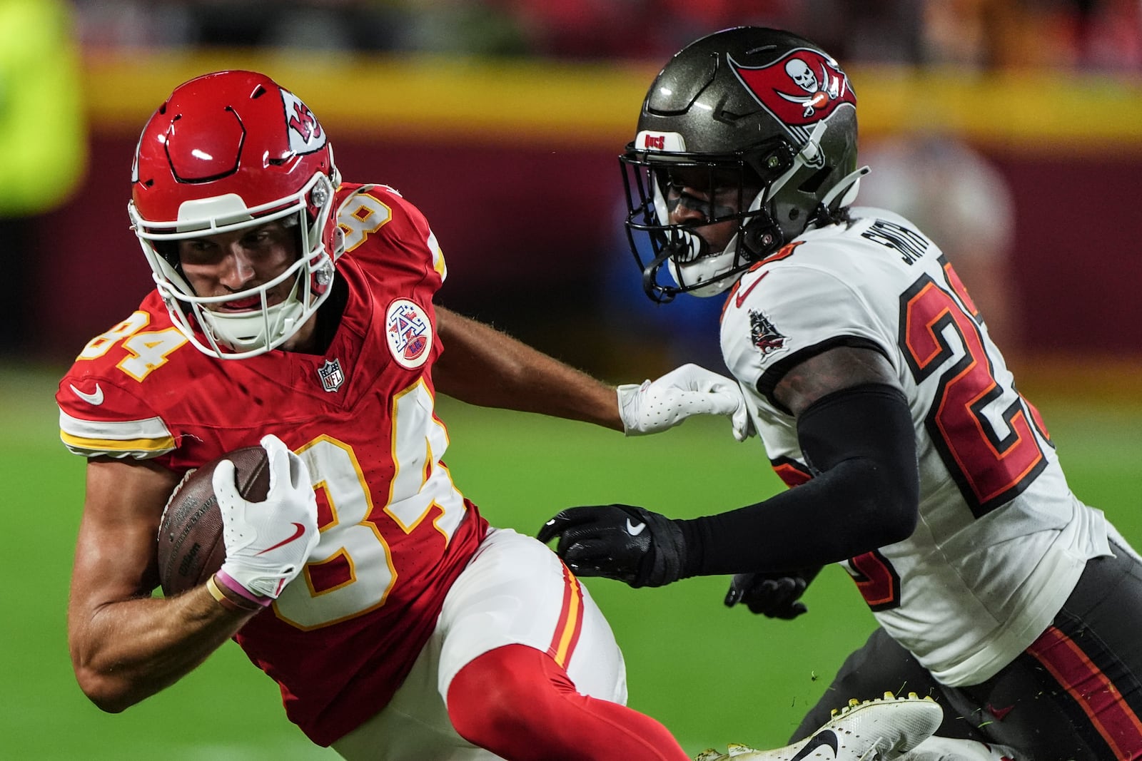 Kansas City Chiefs wide receiver Justin Watson (84) runs against Tampa Bay Buccaneers safety Tykee Smith (23) during the first half of an NFL football game, Monday, Nov. 4, 2024, in Kansas City, Mo. (AP Photo/Charlie Riedel)