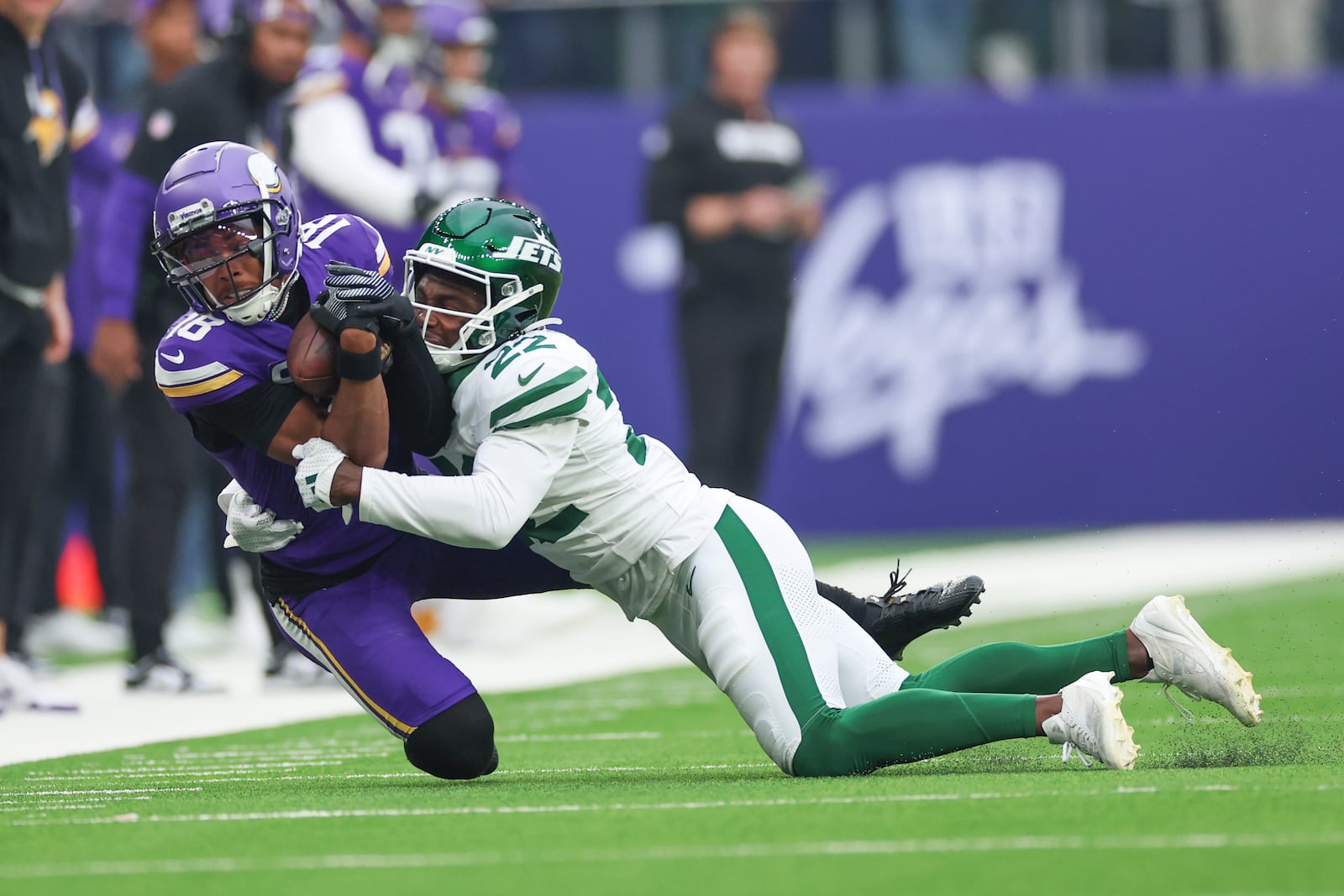 New York Jets' Tony Adams, right, tackles Minnesota Vikings' Justin Jefferson during the first half of an NFL football game, Sunday, Oct. 6, 2024, at the Tottenham Hotspur stadium in London. (AP Photo/Ian Walton)