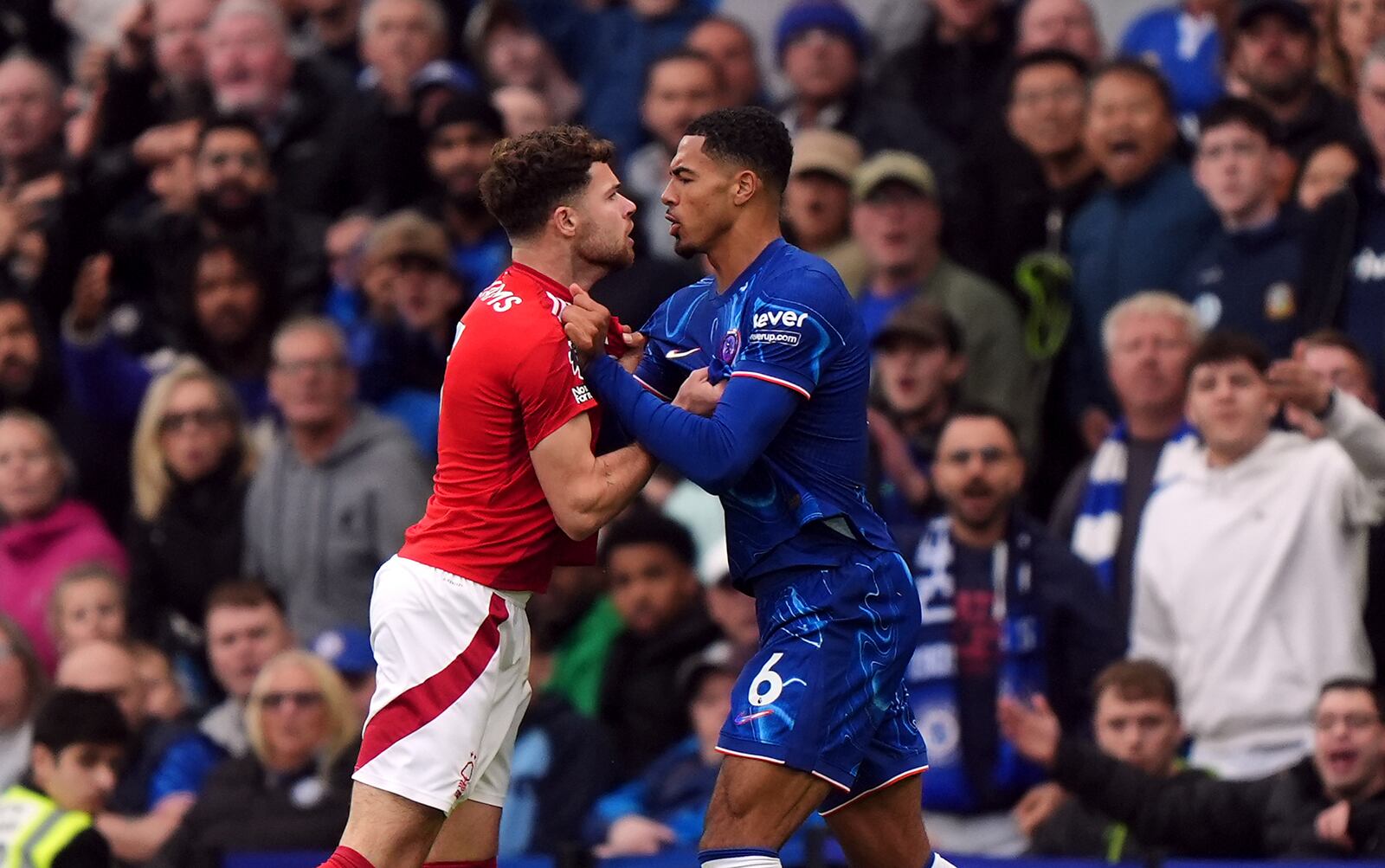 Tempers flare between Nottingham Forest's Neco Williams and Chelsea's Levi Colwill, right, during the English Premier League soccer match between Chelsea and Nottingham Forest at Stamford Bridge in London, Sunday Oct. 6, 2024. (Bradley Collyer/PA via AP)