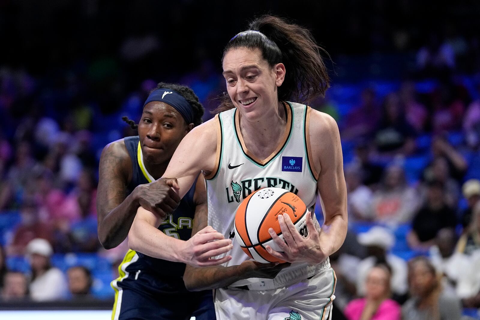 New York Liberty's Breanna Stewart, right, is fouled while grabbing a rebound by Dallas Wings' Natasha Howard, left, in the first half of a WNBA basketball game, Thursday, Sept. 12, 2024, in Arlington, Texas. (AP Photo/Tony Gutierrez)