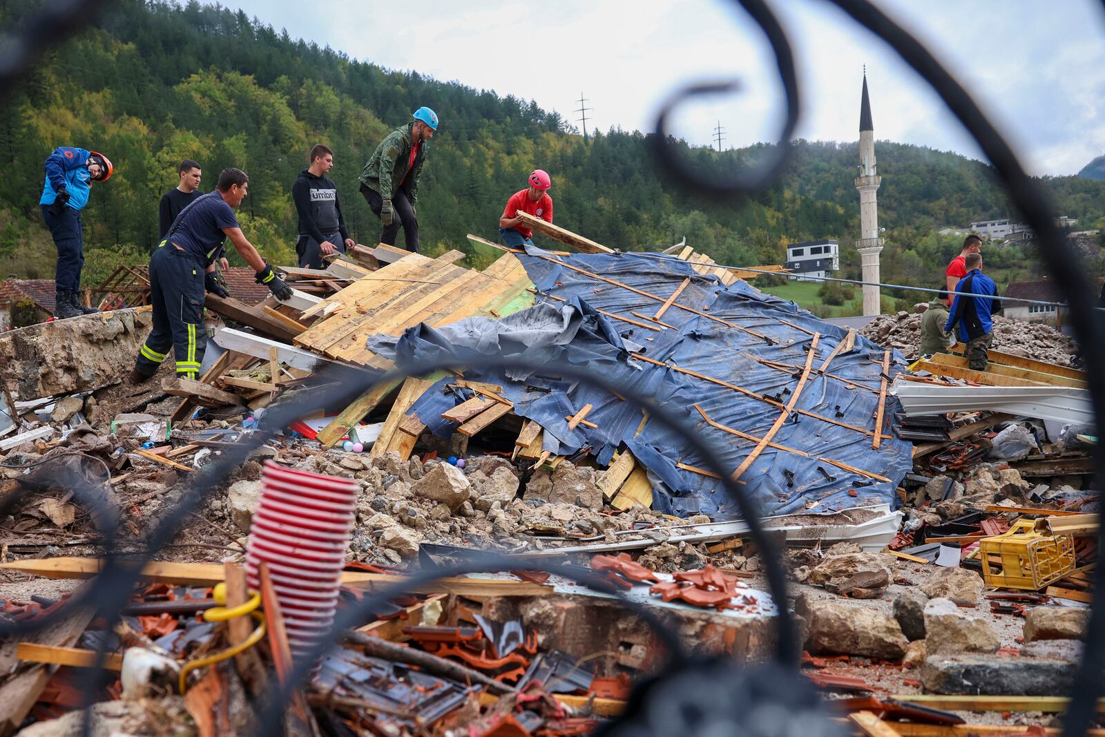 Rescuers search for missing people after floods and landslides in the village of Donja Jablanica, Bosnia, Saturday, Oct. 5, 2024. (AP Photo/Armin Durgut)