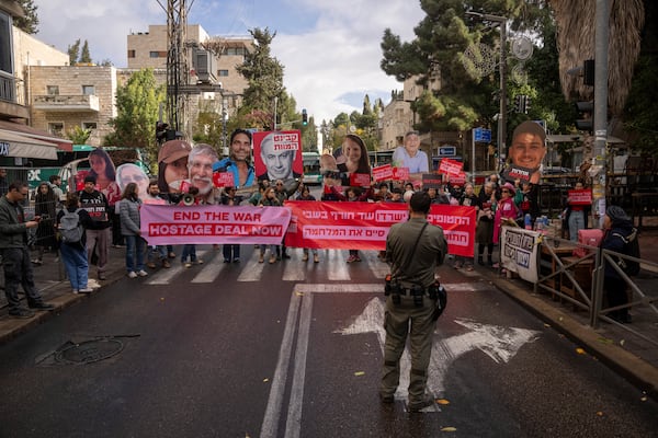 Families and supporters of Israeli hostages held by Hamas in Gaza, hold photos of their loved ones during a protest calling for their release outside the prime minister's house in Jerusalem, Monday, Nov. 18, 2024. (AP Photo/Ohad Zwigenberg)