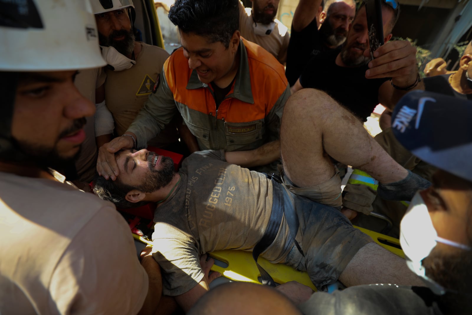 FILE - A survivor is taken out of the rubble after a massive explosion in Beirut, on Aug. 5, 2020. (AP Photo/Hassan Ammar, File)