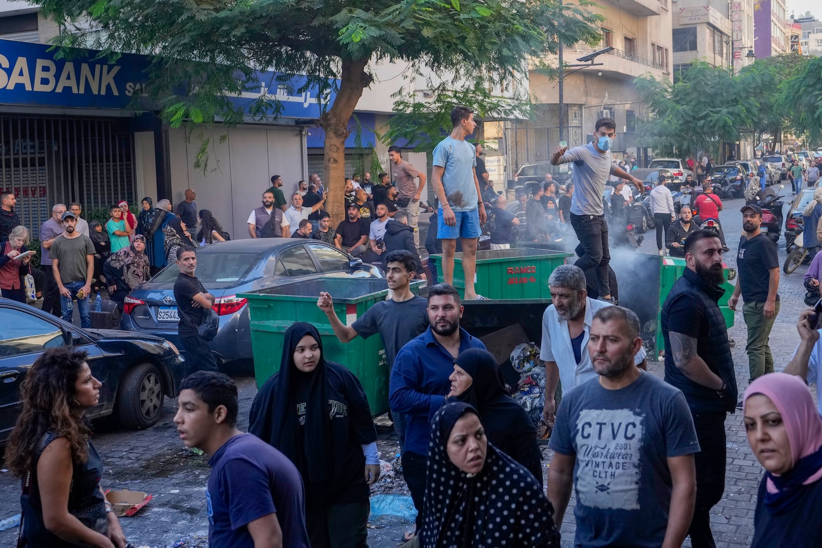 FILE - People displaced by Israel's war on Hezbollah gesture after scuffle with members of the Lebanese security, after dozens of policemen arrived at the building to evict the displaced from the private property, in Beirut, Lebanon, Monday, Oct. 21, 2024. (AP Photo/Hassan Ammar, File)