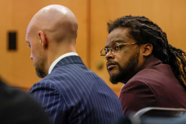 Shannon Stillwell, right, sits with his attorney, Max Schardt left, as he looks at the prosecutors during the Young Thug trial at Fulton County Courthouse in Atlanta on Tuesday, Nov. 26, 2024. (Miguel Martinez/Atlanta Journal-Constitution via AP)