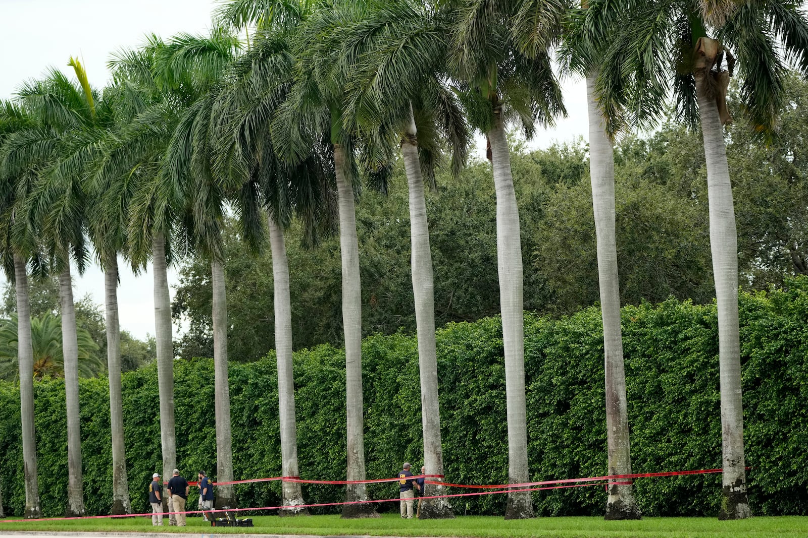 Law enforcement officials work at the scene of the Trump International Golf Club in the aftermath of the apparent assassination attempt of Republican presidential nominee and former President Donald Trump Tuesday, Sept. 17, 2024, in West Palm Beach, Fla. (AP Photo/Lynne Sladky)