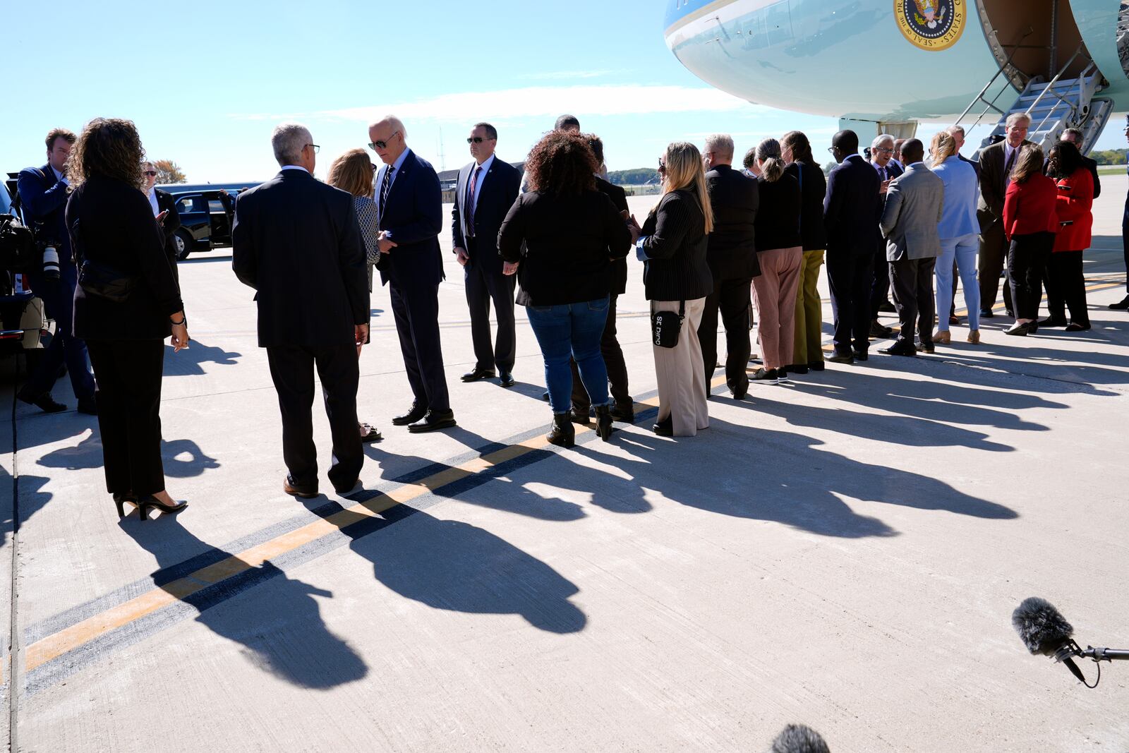 President Joe Biden is greeted by officials after arriving at Milwaukee Mitchell International Airport in Milwaukee, Tuesday, Oct. 8, 2024. (AP Photo/Susan Walsh)