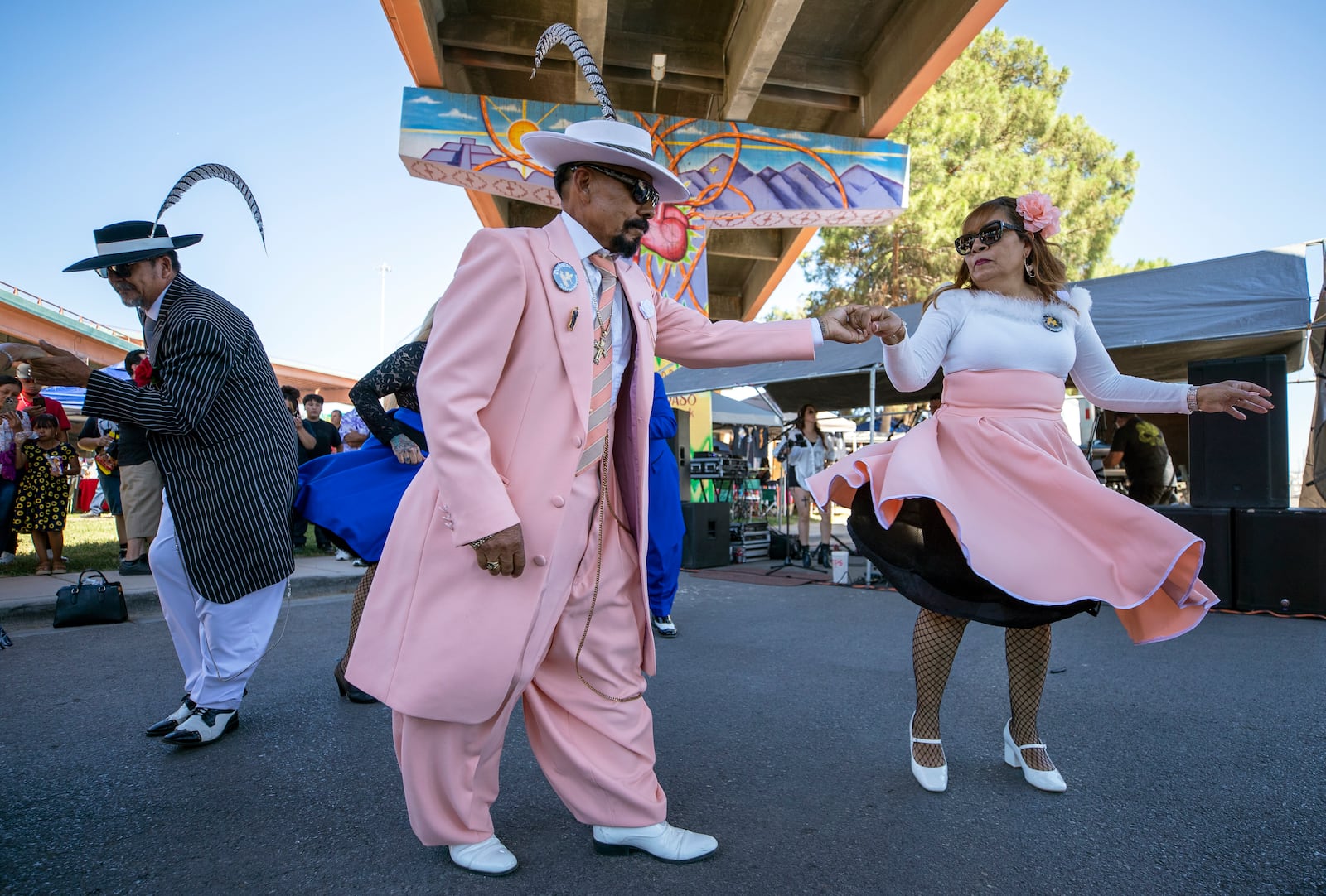 Hugo Cardenas and Araceli Martinez, wearing Zoot suits of the Mexican American subculture known as Pachucos, dance while attending a lowrider exhibition during the 20th anniversary of Lincoln Park in El Paso, Texas, Sunday, Sept. 22, 2024. (AP Photo/Andrés Leighton)