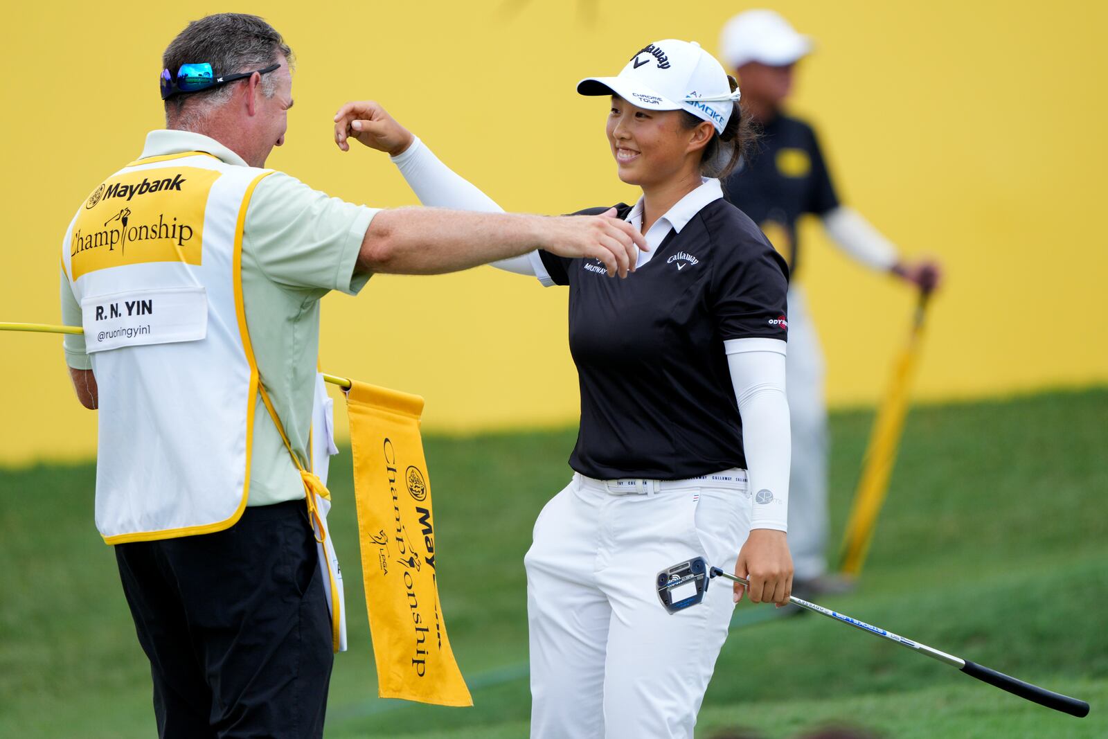 Yin Ruoning of China celebrates with his caddie on the 18th hole after winning the LPGA Tour's Maybank Championship at Kuala Lumpur Golf and Country club in Kuala Lumpur, Sunday, Oct. 27, 2024. (AP Photo/Vincent Thian)