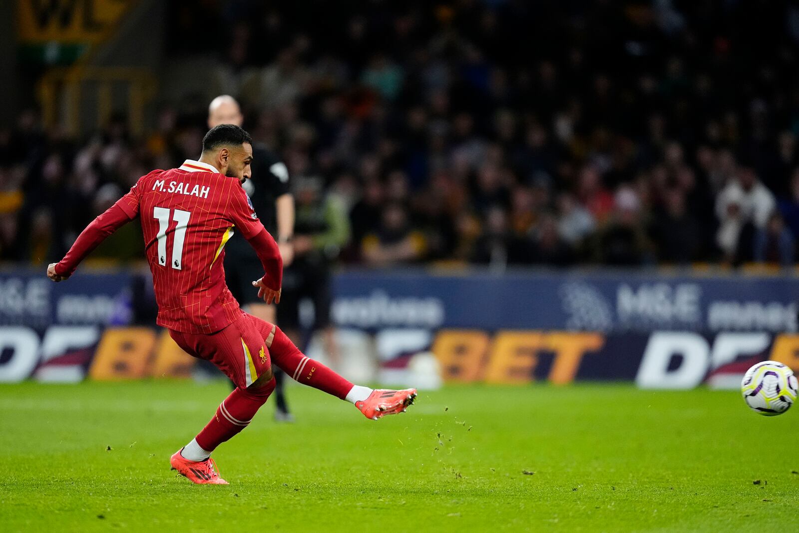 Liverpool's Mohamed Salah scores his side's second goal of the game during the English Premier League soccer match between Wolverhampton Wanderers and Liverpool at the Molineux Stadium in Wolverhampton, England, Saturday, Sept. 28, 2024. (Nick Potts/PA via AP)