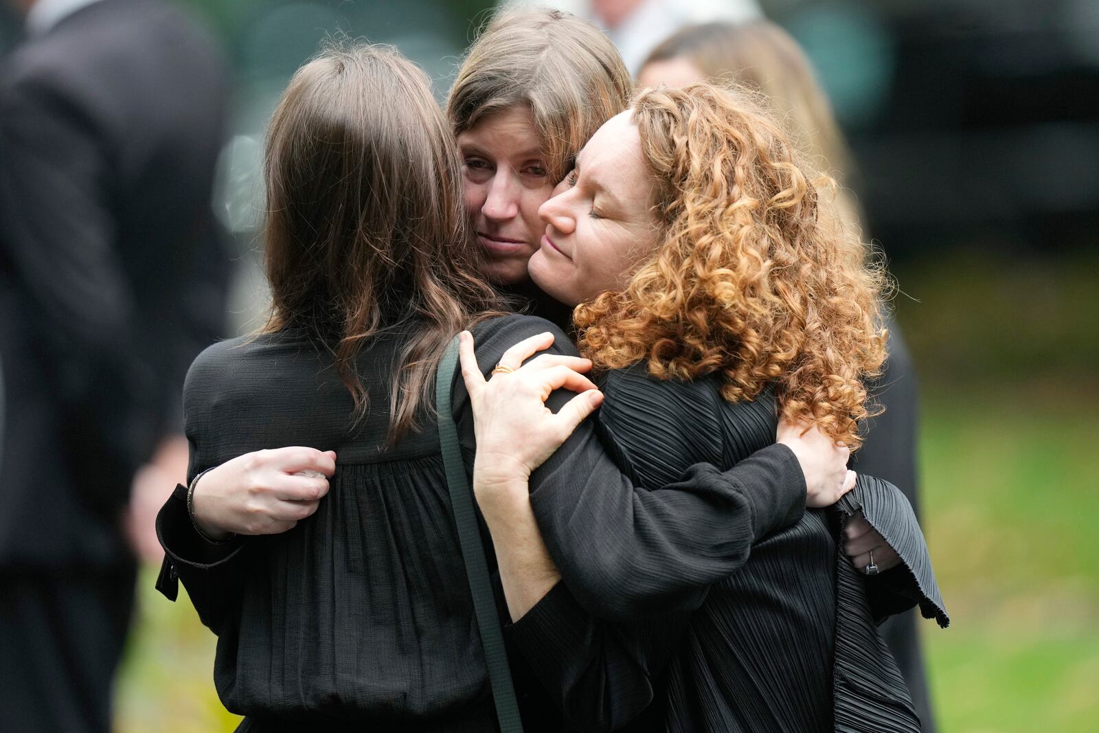 Mourners hug following funeral services for Ethel Kennedy, wife of the late Sen. Robert F. Kennedy, at Our Lady of Victory church, Monday, Oct. 14, 2024, in Centerville, Mass. (AP Photo/Steven Senne)