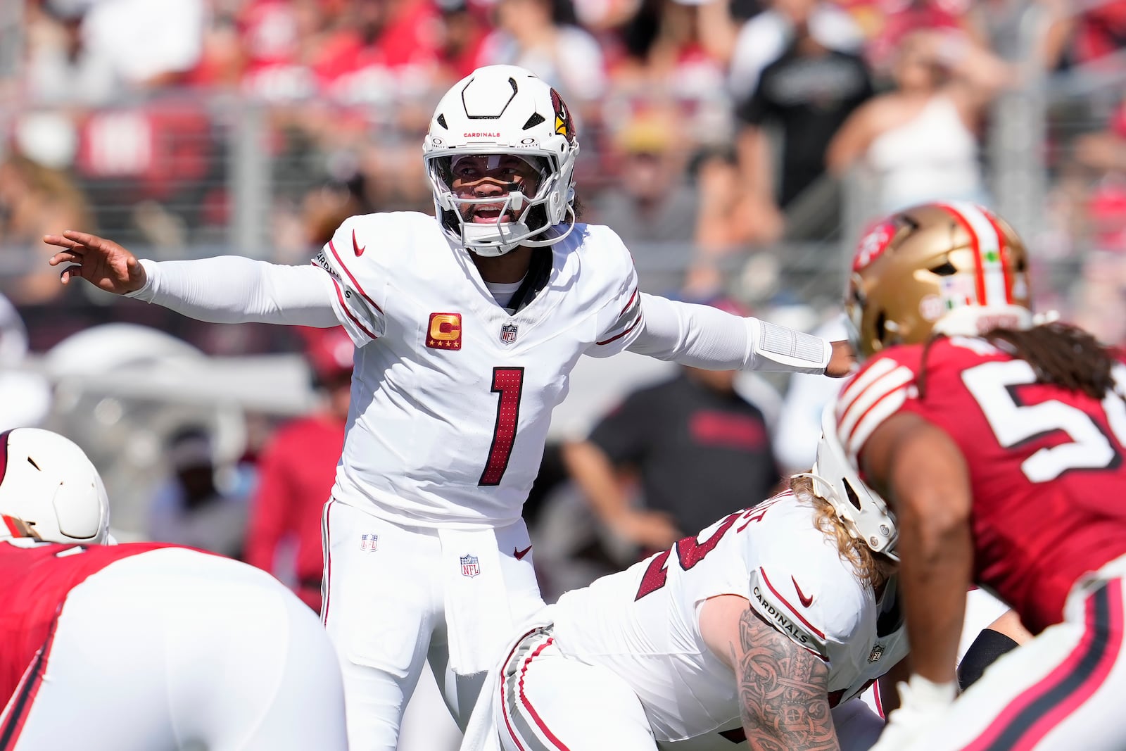 Arizona Cardinals quarterback Kyler Murray (1) gestures behind center at the line of scrimmage during the first half of an NFL football game against the San Francisco 49ers in Santa Clara, Calif., Sunday, Oct. 6, 2024. (AP Photo/Godofredo A. Vásquez)