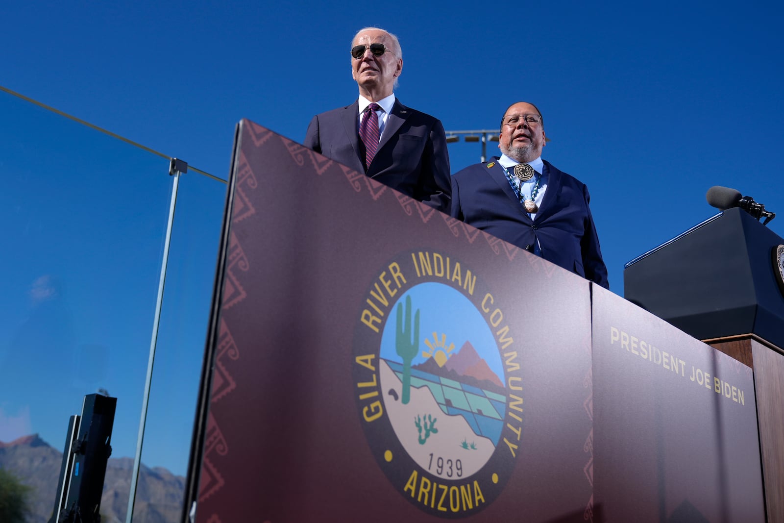 President Joe Biden, left, joined by Stephen Roe Lewis, Governor of the Gila River Indian Community, arrives to speak at the Gila Crossing Community School in the Gila River Indian Community reservation in Laveen, Ariz., Friday, Oct. 25, 2024. (AP Photo/Manuel Balce Ceneta)