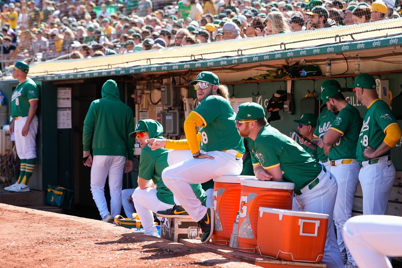 Oakland Athletics'Joey Estes (68) and Kyle McCann, center right, look on from the dugout during a baseball game against the Texas Rangers, Thursday, Sept. 26, 2024, in Oakland, Calif. (AP Photo/Godofredo A. Vásquez)