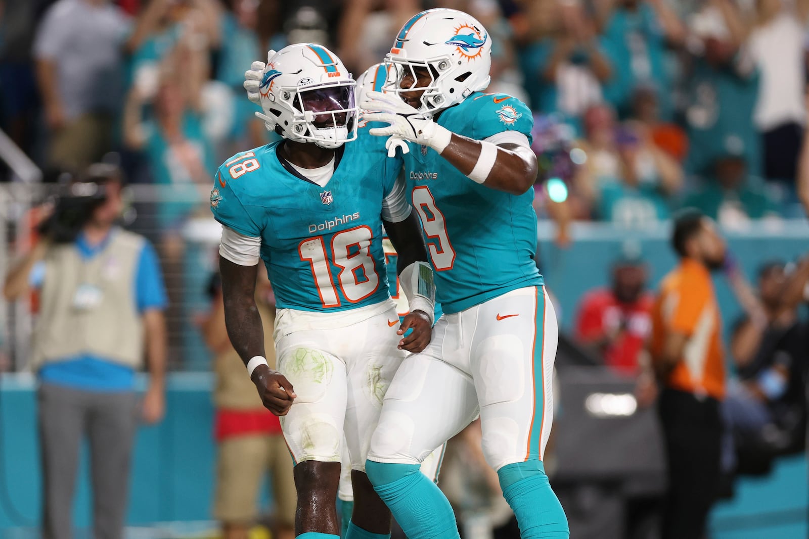 Miami Dolphins quarterback Tyler Huntley (18) celebrates his touchdown with tight end Jonnu Smith (9) during the second half of an NFL football game against the Tennessee Titans, Monday, Sept. 30, 2024, in Miami Gardens, Fla. (AP Photo/Brennan Asplen)