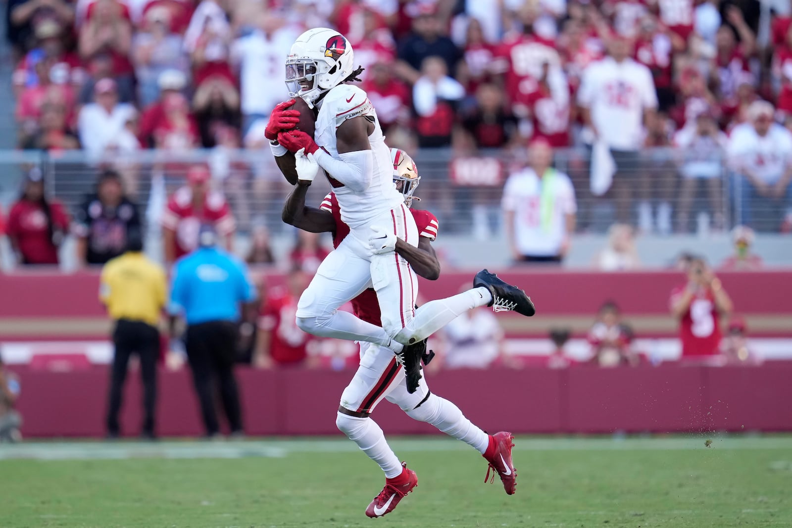 Arizona Cardinals wide receiver Marvin Harrison Jr., top, catches a pass in front of San Francisco 49ers cornerback Isaac Yiadom during the second half of an NFL football game in Santa Clara, Calif., Sunday, Oct. 6, 2024. (AP Photo/Godofredo A. Vásquez)