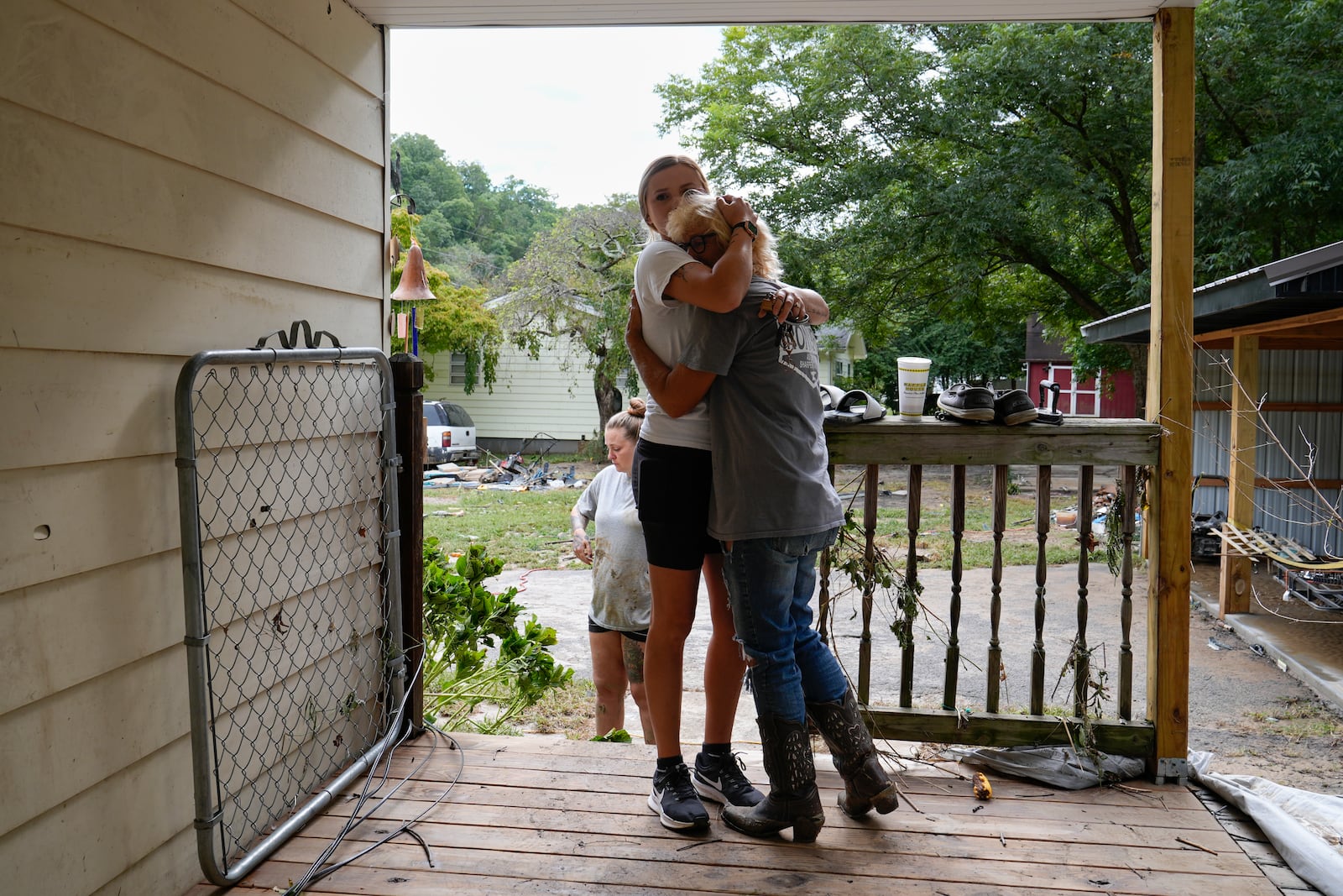 Ashlie Salliotte, left, hugs Janet Sams, right, at Sams' flood damaged home along River Rd, Saturday, Sept. 28, 2024, in Newport, Tenn. (AP Photo/George Walker IV)