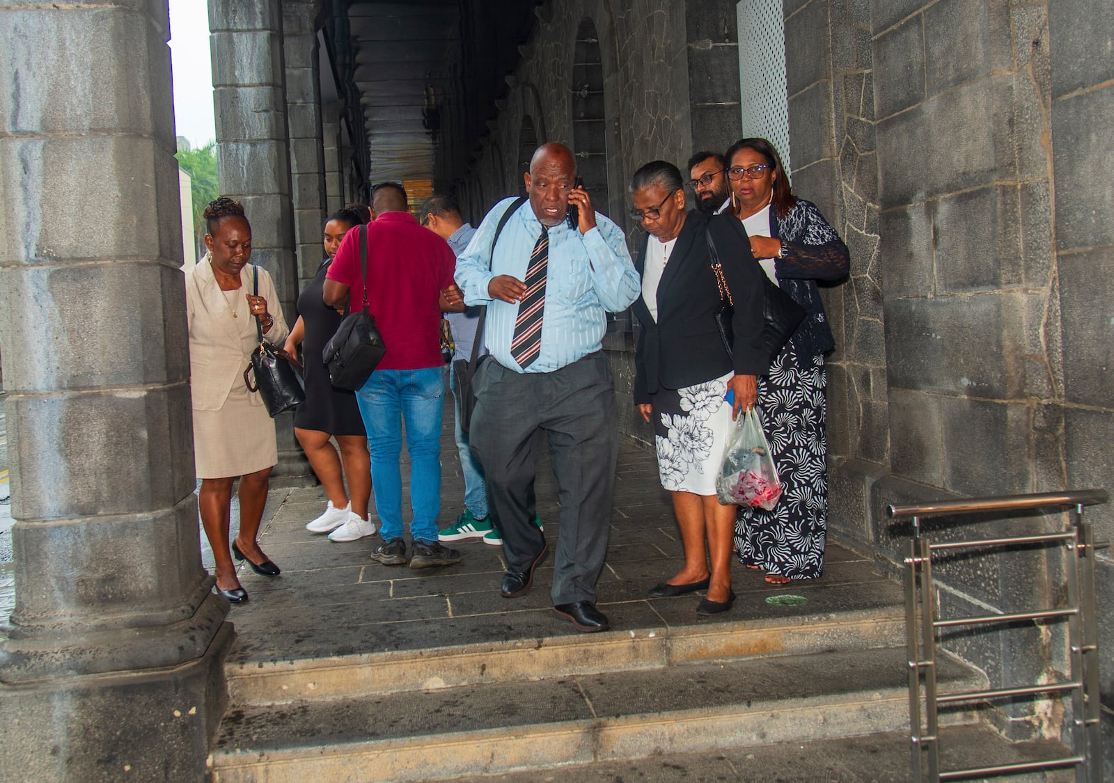 Chagossians, led by Olivier Bancoult, on phone at centre, outside the Mauritian Prime Minister's office in Port Louis, Mauritius, Thursday, Oct. 3, 2024 after the news that the U.K. had agreed to hand sovereignty of the long-contested Chagos Islands to Mauritius. (Sokrah Kiranchand/l'Express Mauritius via AP)